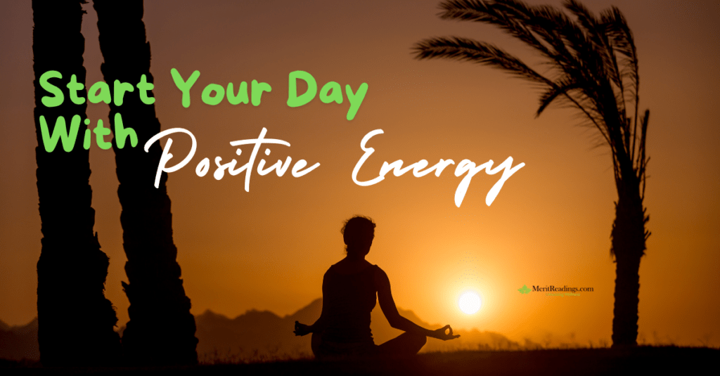 A silhouette of a person sitting cross-legged in a meditative pose at sunrise, with palm trees in the background. The text overlay reads "Start Your Day With Positive Energy" in bold, green and white fonts. The logo for MeritReadings.com, featuring a green leaf symbol, is visible in the lower right corner. morning meditation for positive energy