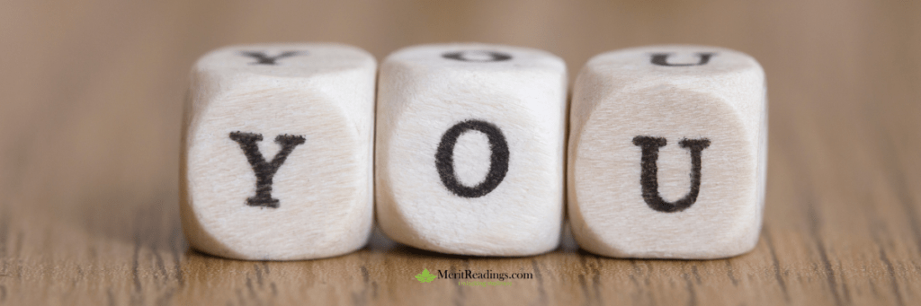 Wooden blocks with the letters "Y," "O," and "U" arranged to spell "YOU" on a wooden surface.