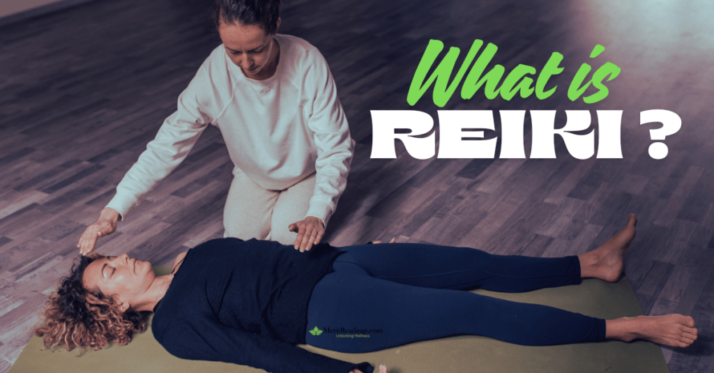 Reiki practitioner performing energy healing on a woman lying on a yoga mat during a Reiki session.